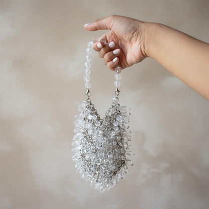 Crystal Cascade Mini Bag in clear and silver held by hand with long white nails